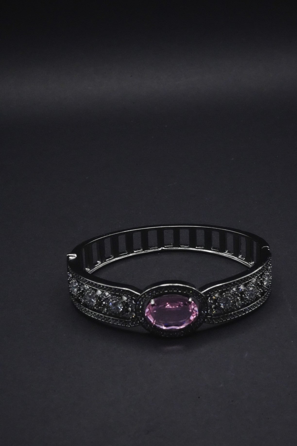 Elegant Black Bangle with Pink Oval Gemstone and Clear Crystal Accents