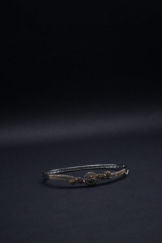 Delicate Silver coated Bangle with Rose Gold Accents and Intricate Knot Design