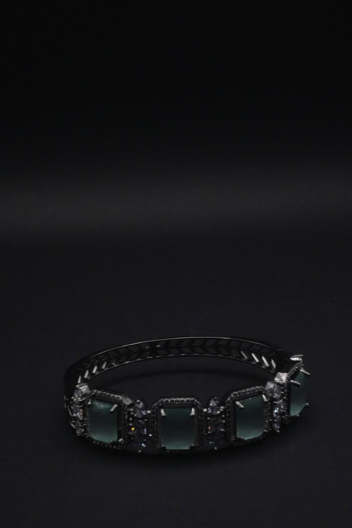 Elegant Silver coated Bangle with Green Rectangular Gemstones and Clear Crystal Accents