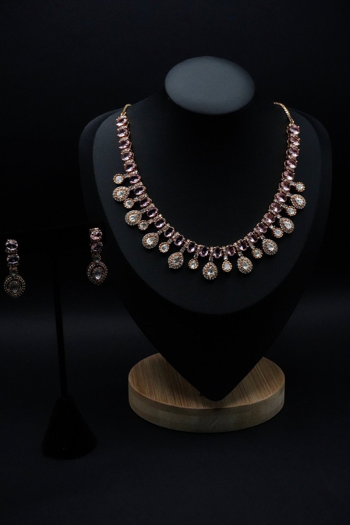 Stunning necklace set featuring stones in soft pink and clear hues, beautifully arranged in round and teardrop shapes.