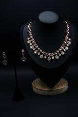 Stunning necklace set featuring stones in soft pink and clear hues, beautifully arranged in round and teardrop shapes.