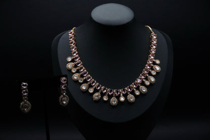 Stunning necklace set featuring stones in soft pink and clear hues, beautifully arranged in round and teardrop shapes.