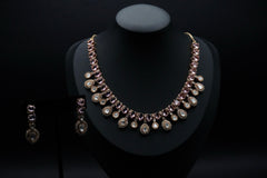 Stunning necklace set featuring stones in soft pink and clear hues, beautifully arranged in round and teardrop shapes.