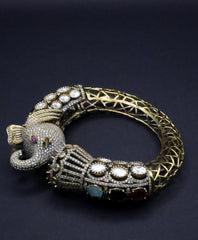 Luxurious Golden coated Serpent Bangle with Multi-Gem Accents