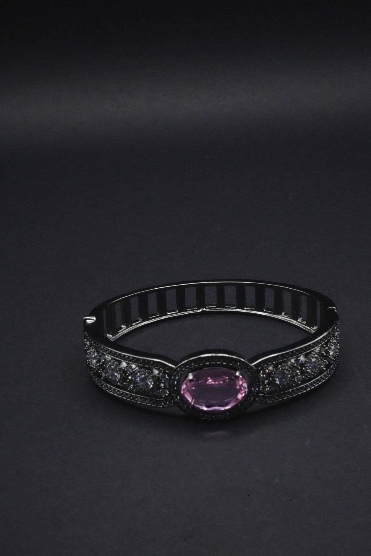 Elegant Black Bangle with Pink Oval Gemstone and Clear Crystal Accents