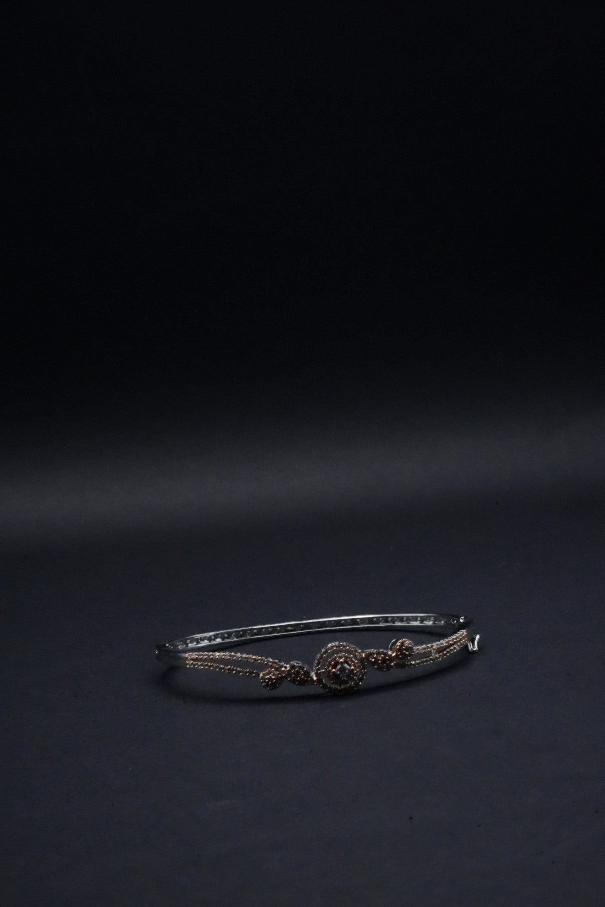 Delicate Silver coated Bangle with Rose Gold Accents and Intricate Knot Design