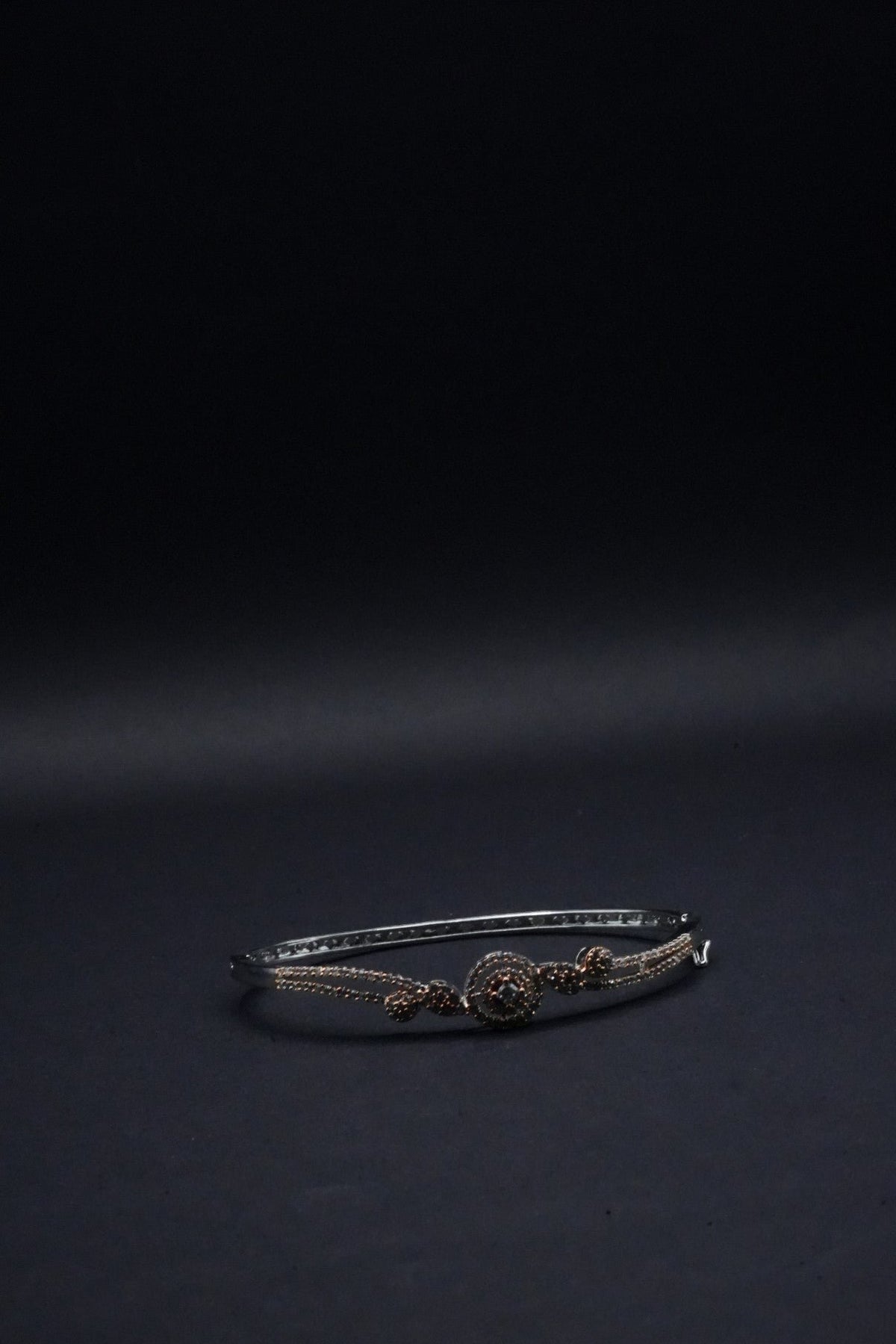 Delicate Silver coated Bangle with Rose Gold Accents and Intricate Knot Design