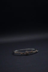 Delicate Silver coated Bangle with Rose Gold Accents and Intricate Knot Design