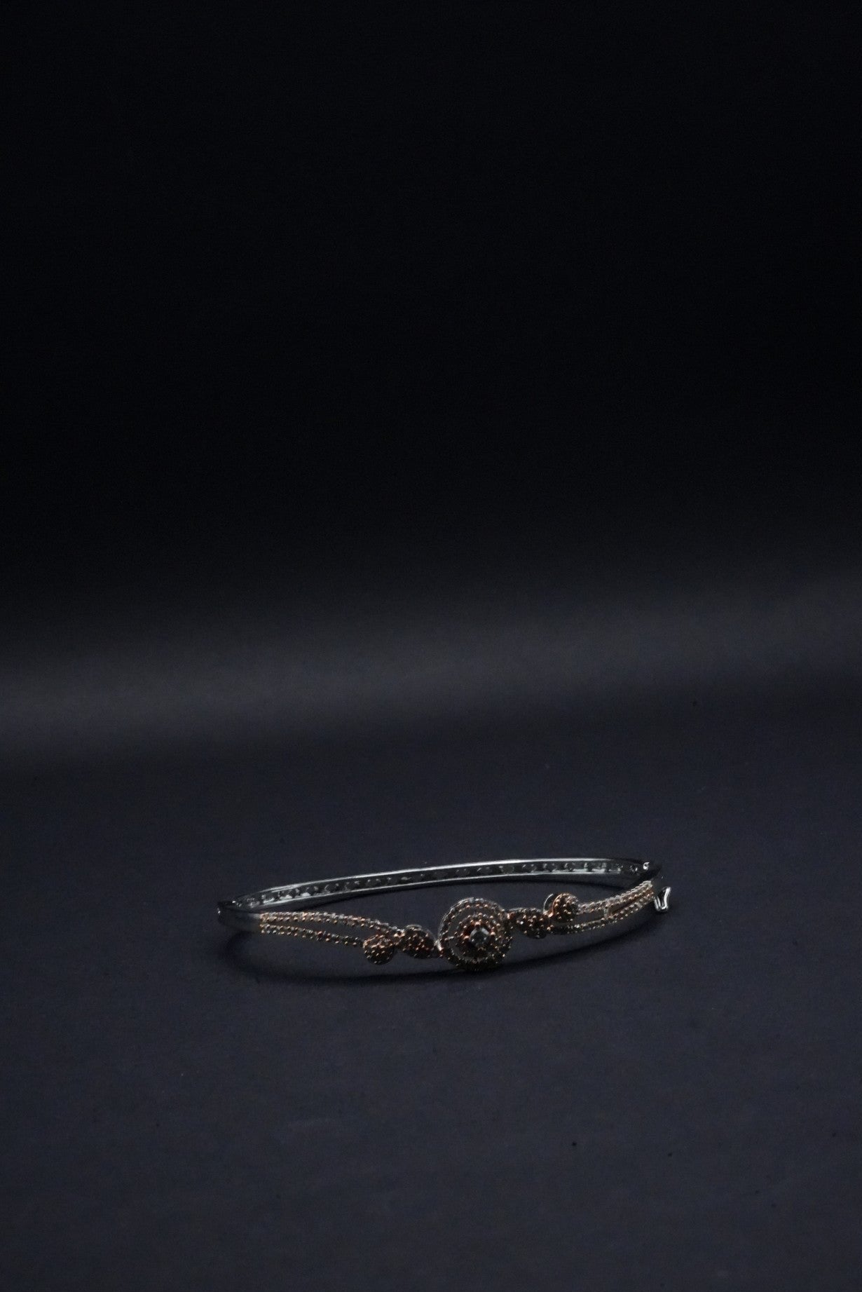 Delicate Silver coated Bangle with Rose Gold Accents and Intricate Knot Design