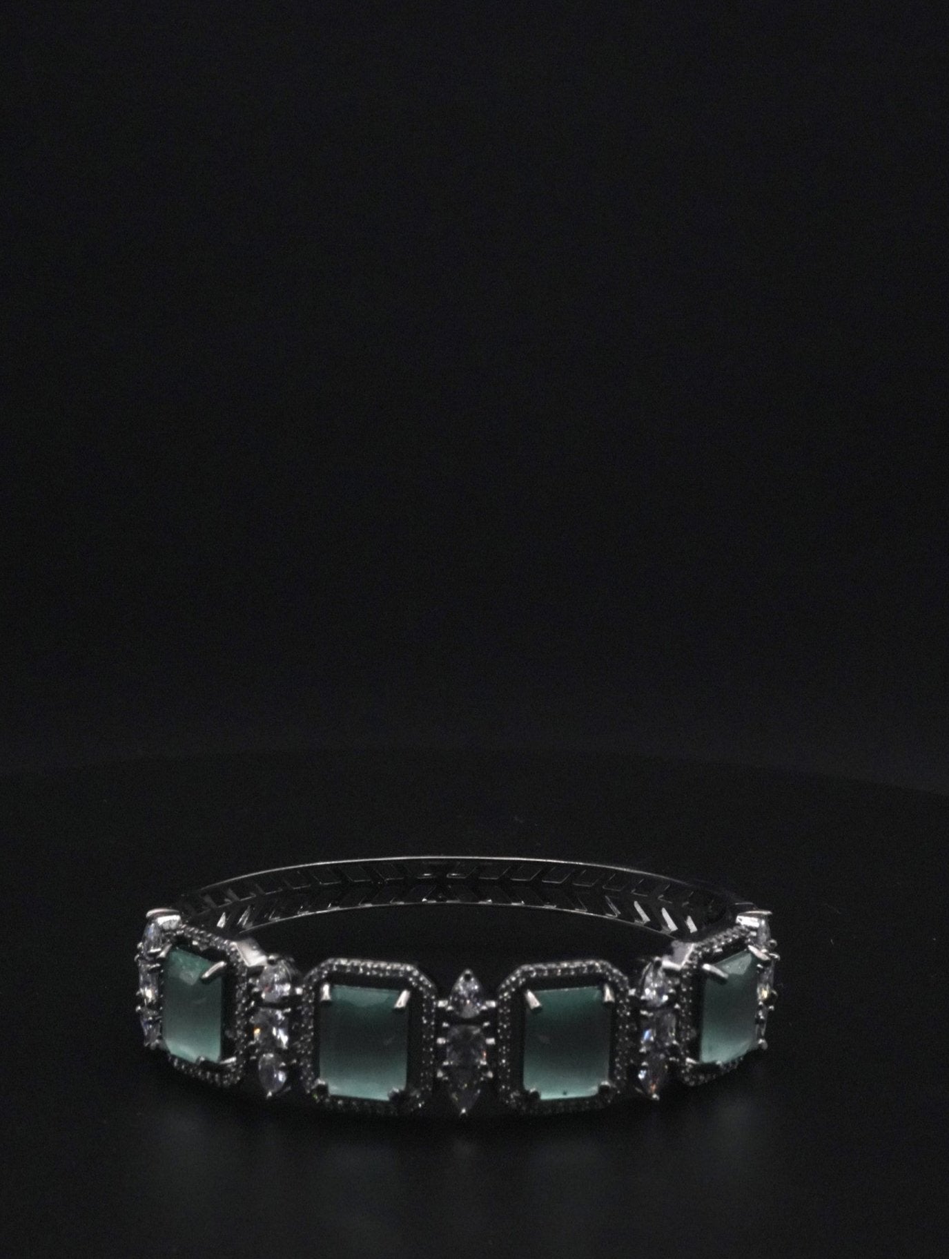 Elegant Silver coated Bangle with Green Rectangular Gemstones and Clear Crystal Accents