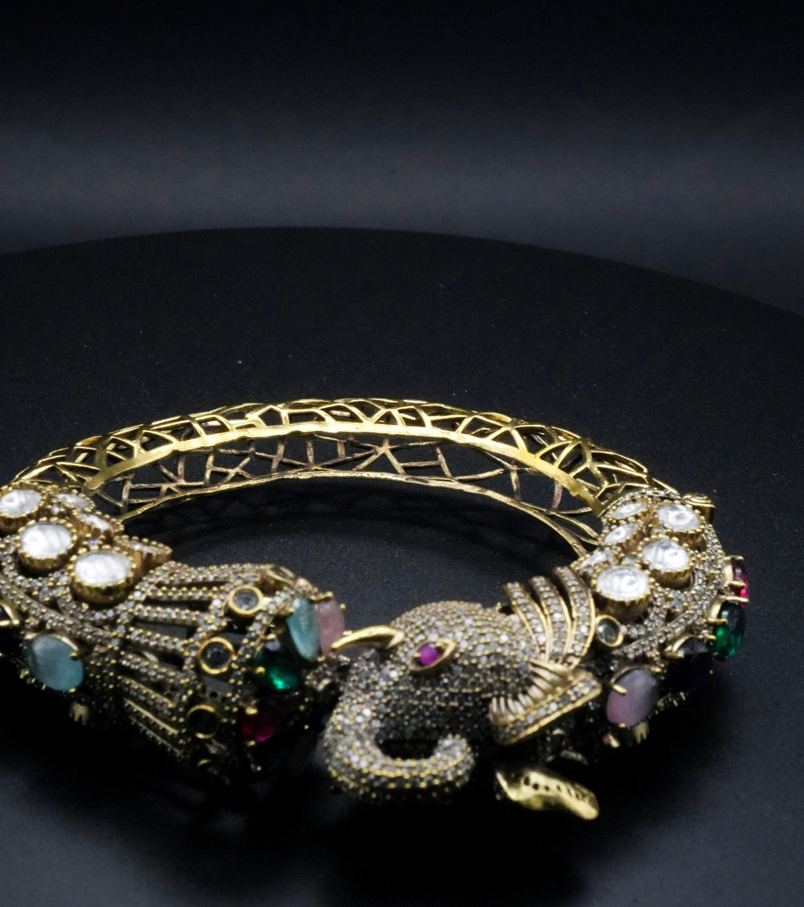 Luxurious Golden coated Serpent Bangle with Multi-Gem Accents