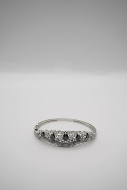 Elegant Silver Coated Bangle with Black Teardrop and Clear Crystal Accents