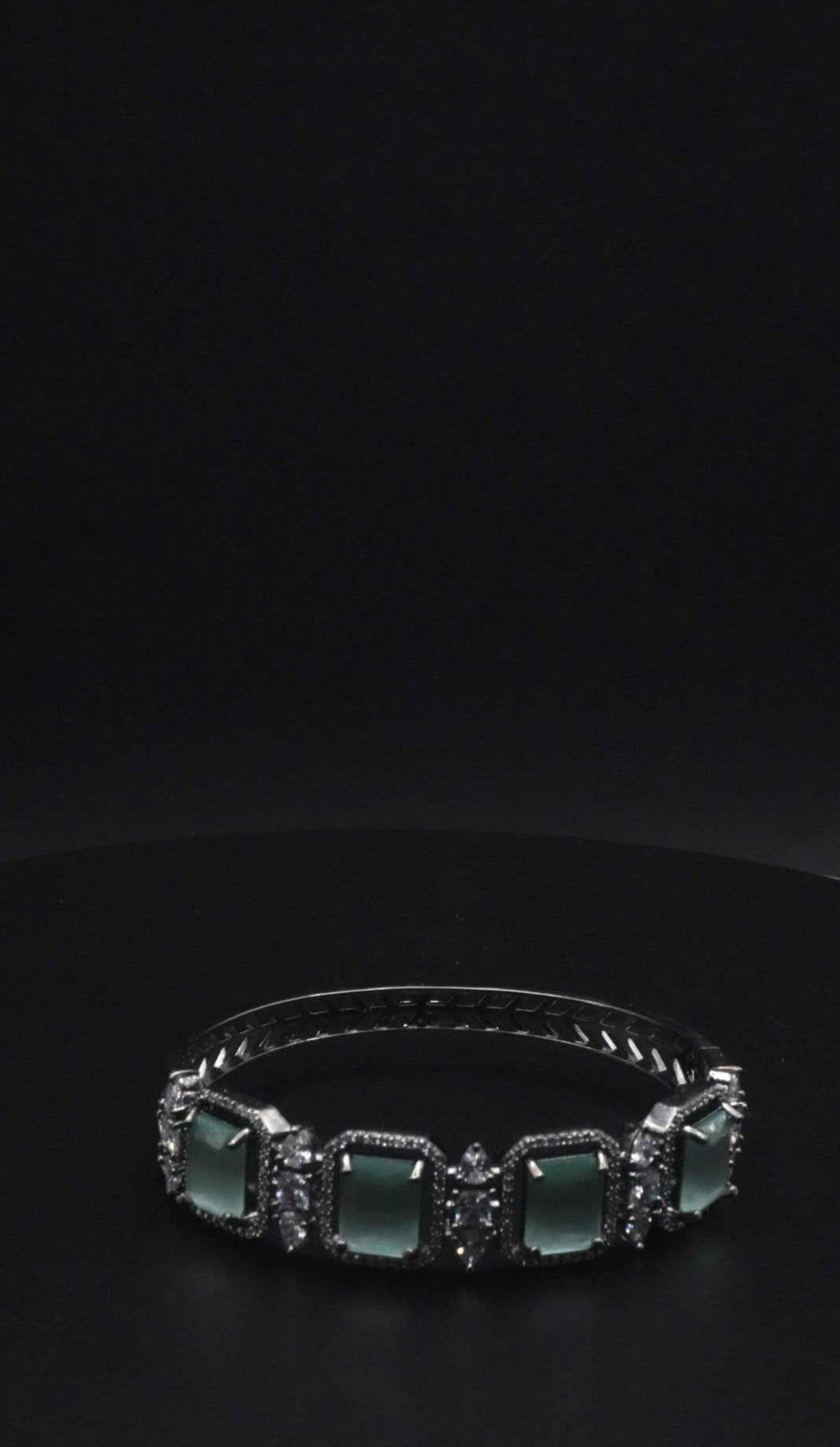 Elegant Silver coated Bangle with Green Rectangular Gemstones and Clear Crystal Accents