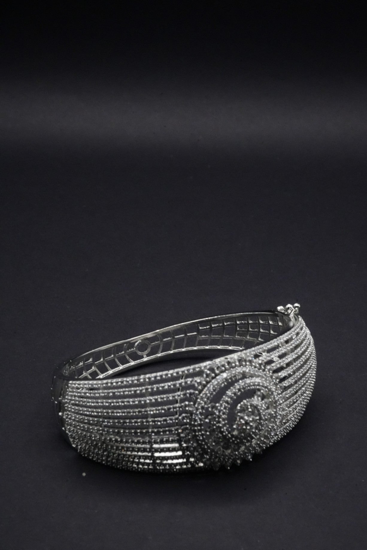 Stunning Silver coated Bangle with Intricate Spiral and Linear Crystal Design