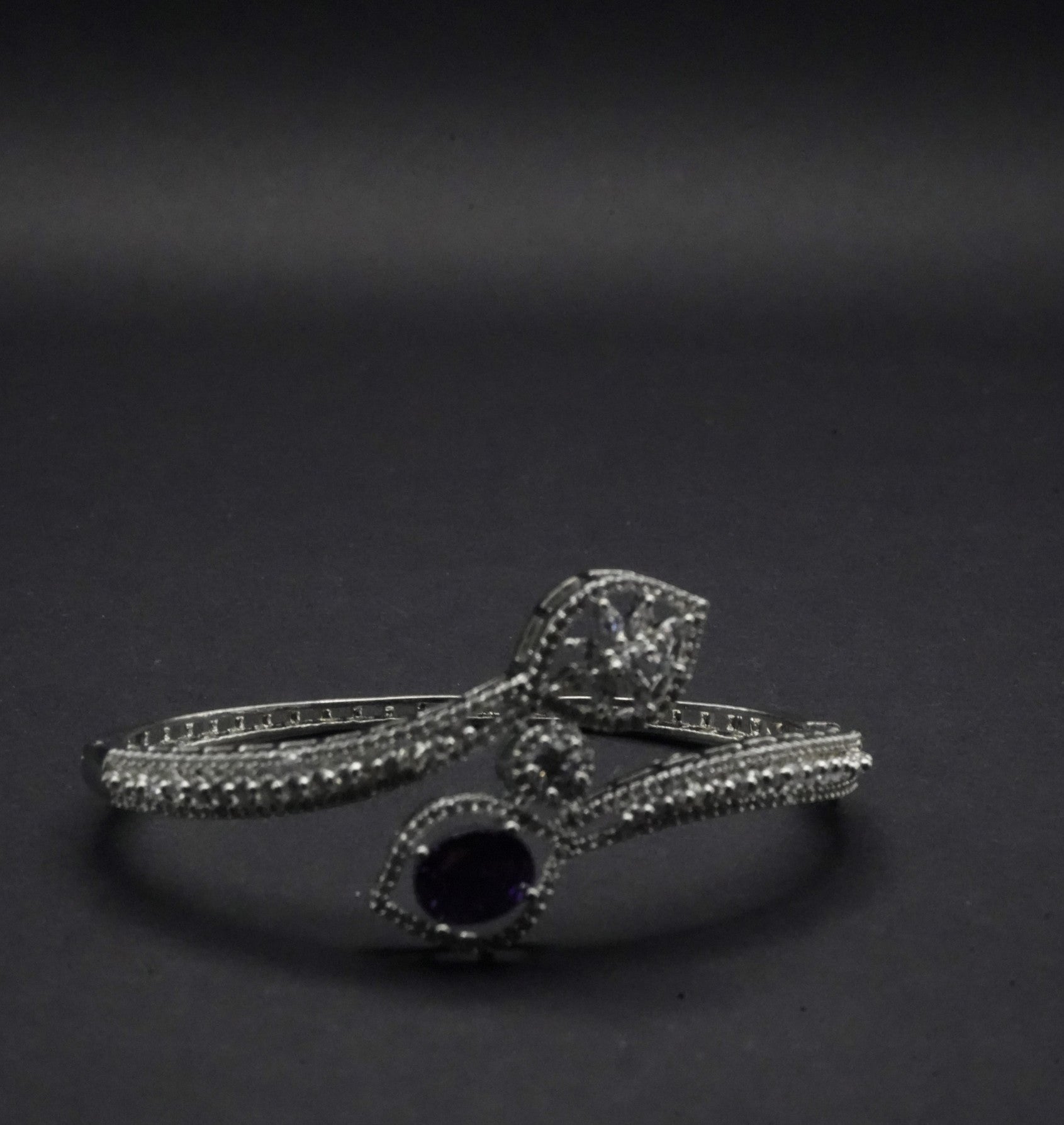 Sophisticated Silver coated Bangle with Dual Stone Accents and CZ Stones like Detailing