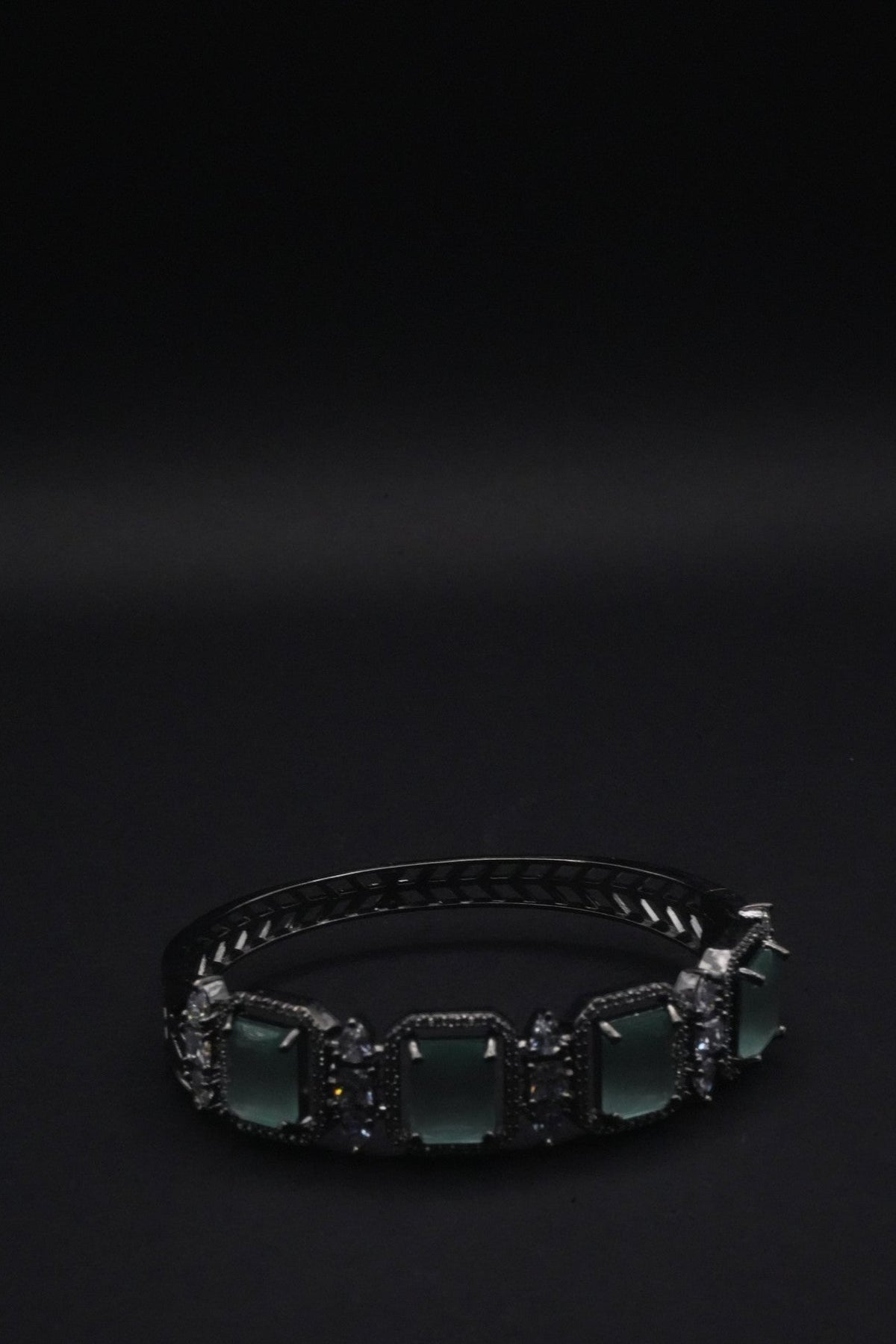 Elegant Silver coated Bangle with Green Rectangular Gemstones and Clear Crystal Accents