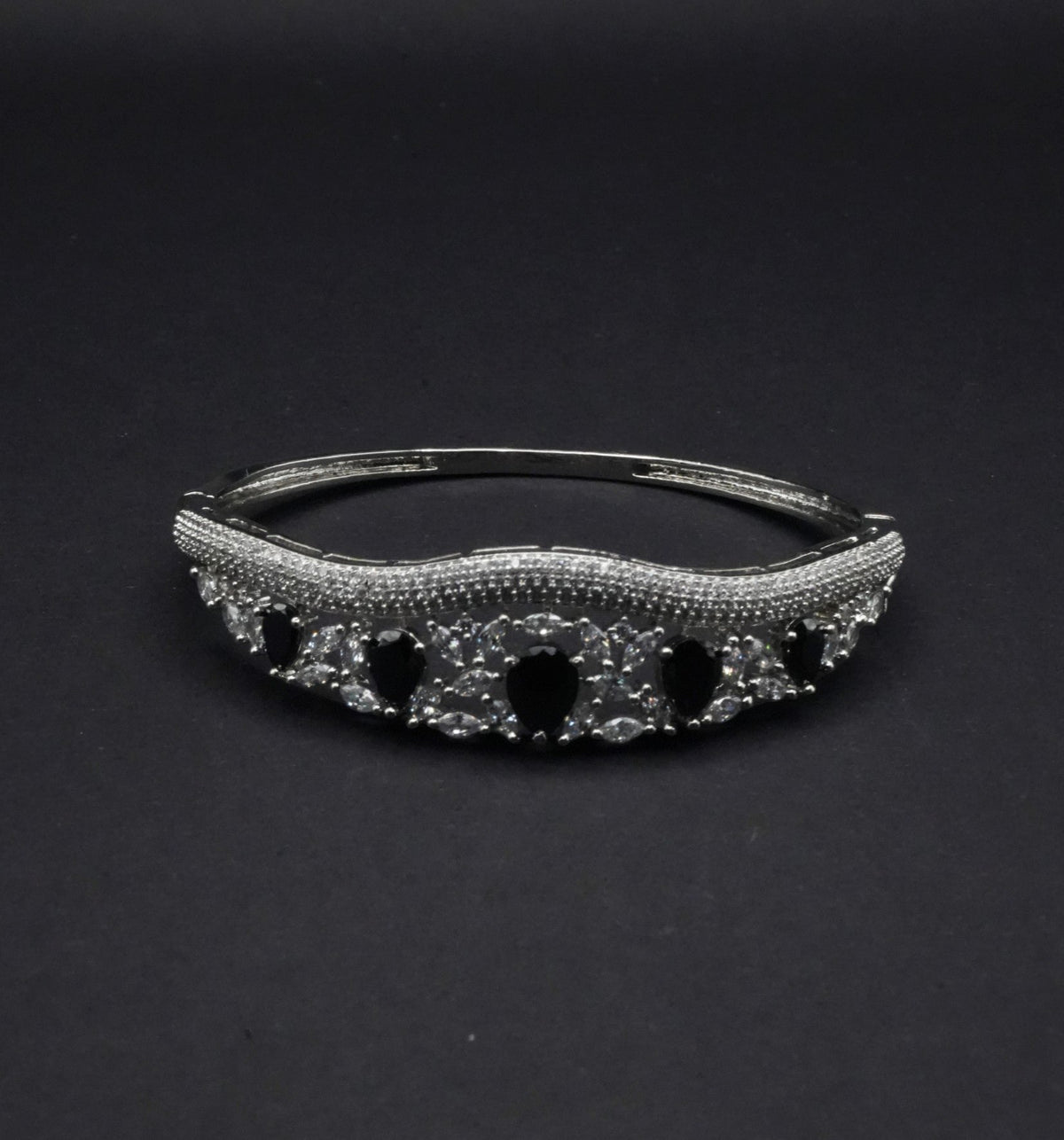 Elegant Silver Coated Bangle with Black Teardrop and Clear Crystal Accents