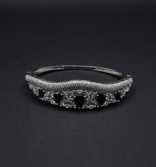 Elegant Silver Coated Bangle with Black Teardrop and Clear Crystal Accents